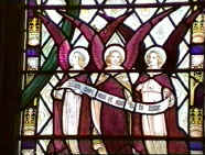 A portion of the Littlewood window showing angels with the inscription "Holy, holy, holy is the Lord..."