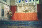 The high altar and sanctuary adorned for Pentecost.